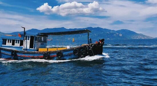 Tranquil Nha Trang shore at dawn for a Nha Trang Tours banner by Legend Travel Group.